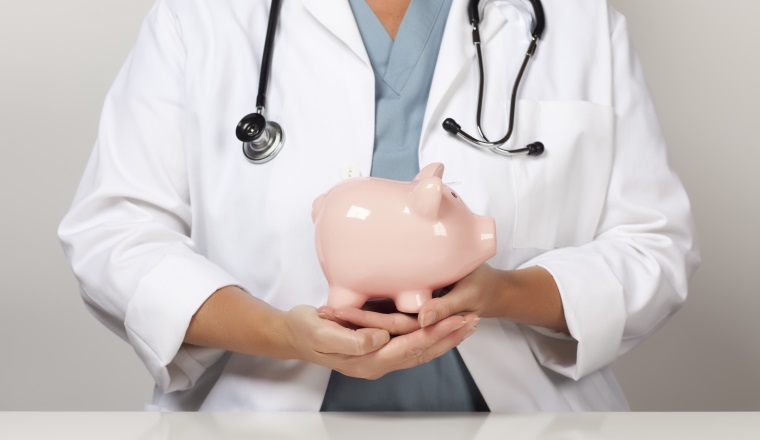 Female Doctor with Stethoscope Holding Piggy Bank Abstract.