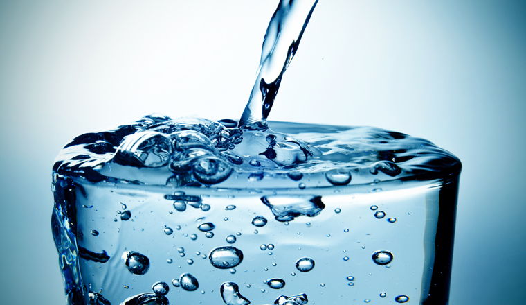 closeup of a refreshing glass of water which is being filled