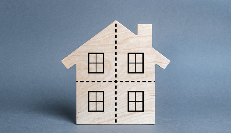 Residential building divided by a dotted line into four equal parts. Divorce concept. Disputes over division process of real estate and property after divorce. Distribution of the right