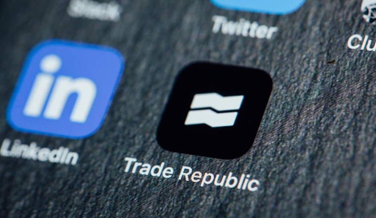 BERLIN, GERMANY - JANUARY 29, 2021: Close up to app of stock trading app Trade Republic on the screen of an iPhone 7 Plus with personalized background.