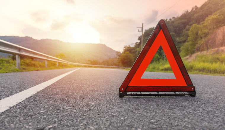 Red triangle, red emergency stop sign, red emergency symbol on road. 