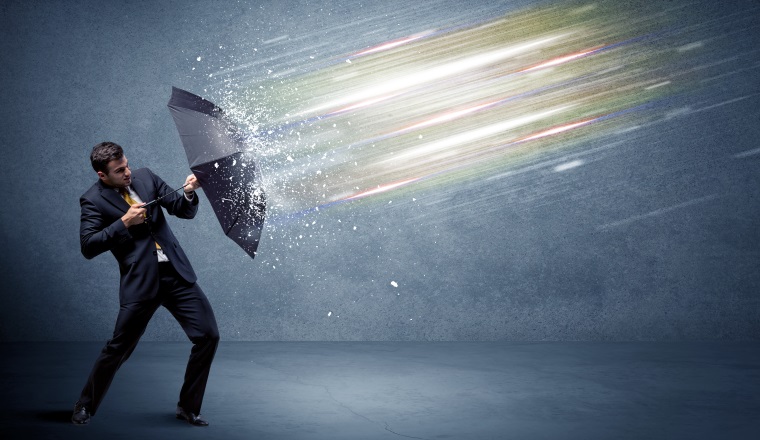 Business man defending light beams with umbrella concept on background