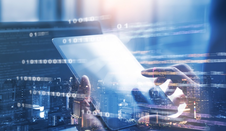 Business and technology, software development, IoT, wireless network communication concept. Double exposure, man programmer, software developer working on digital tablet and smart city with binary, html computer code on screen