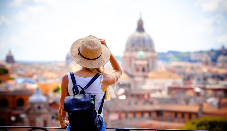 Rome Europe Italia travel summer tourism holiday vacation background -young smiling girl with mobile phone camera and map in hand standing on the hill looking on the cathedral Vatican