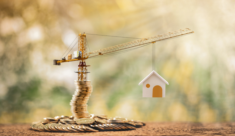 Stacking gold coins with increase and tower crane and hoist brake solutions with build new house in the public park, saving money and loan for construction real estate and home concept.