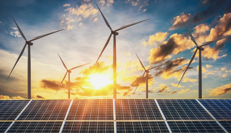 wind turbine with solar panels and sunset. concept clean energy