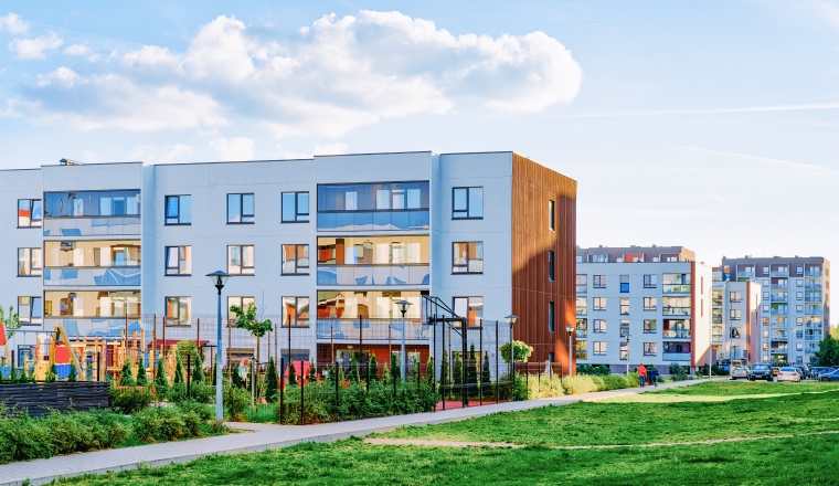 Modern residential apartments and flats buildings exterior and outdoor facilities. New luxury house and home complex and green yard. City Real estate property and condo architecture. Empty background