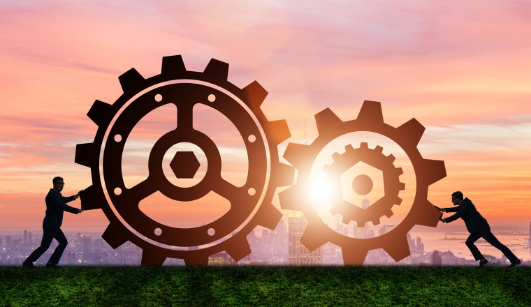 Businessman in teamwork concept with cogwheels