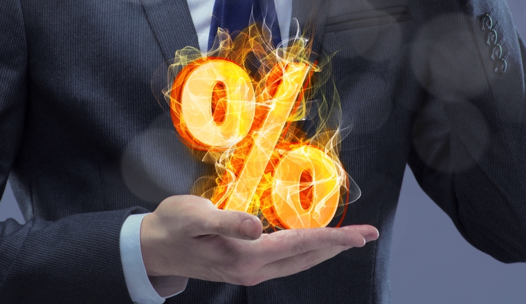 Businessman with percent sign in high interest concept