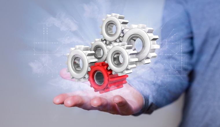 Man with gears and circuit diagram in the hand.