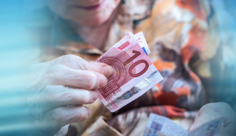 Old woman sitting at home counting her money; panoramic banner