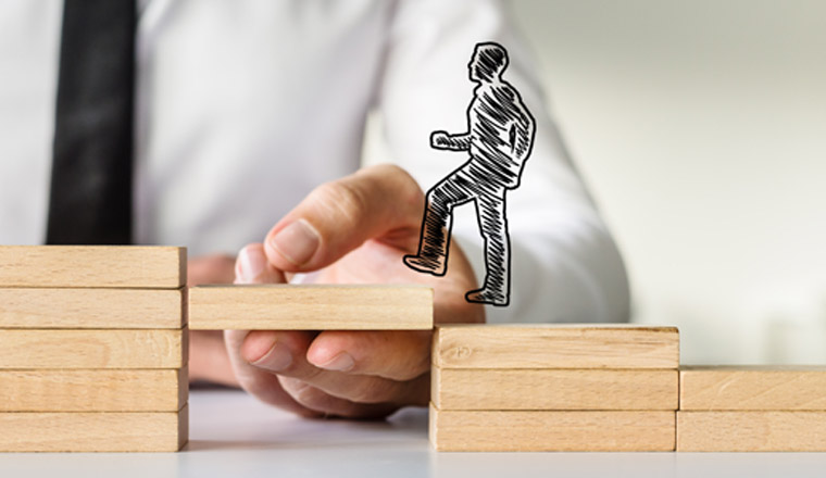 Wide view image of hand drawn shape of a businessman walking up the wooden steps supported by male hand. Conceptual of business teamwork and collaboration.