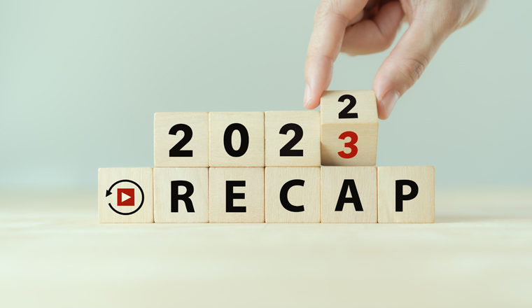 2022 Recap economy, business, financial concept. Business plan in 2023.  RECAP words, 2022 and 2023 on wooden cubes on smart grey background and copy space.