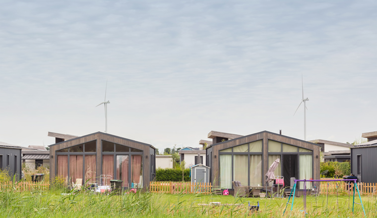 Row of new Dutch wooden based tiny houses with gardens in the city of Almere, The Netherlands