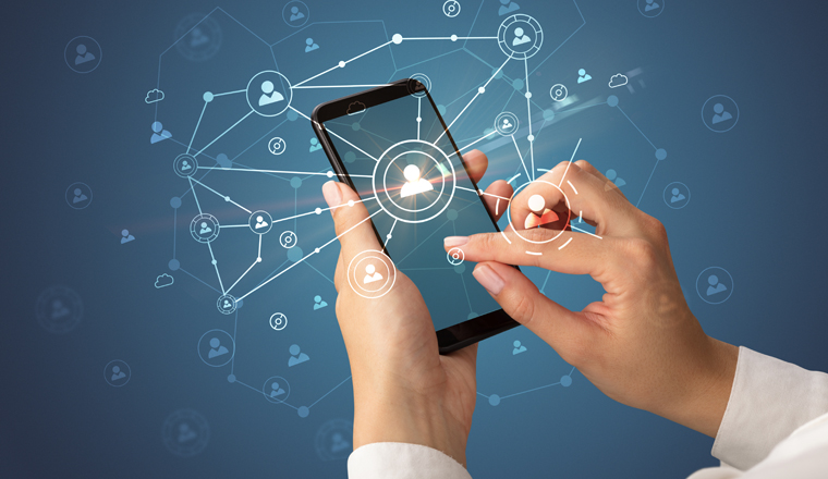 Female hand using smartphone to connect peoples all around the online surface