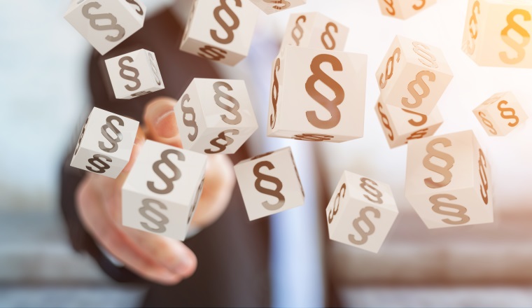 Businessman on blurred background using 3D rendering law cubes