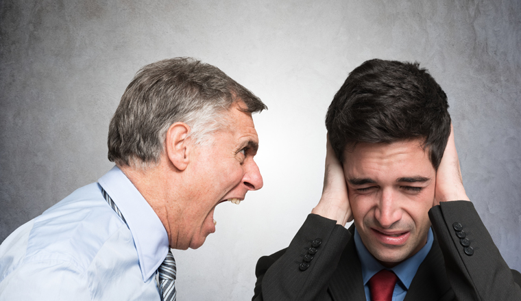 Angry businessman shouting to an employee