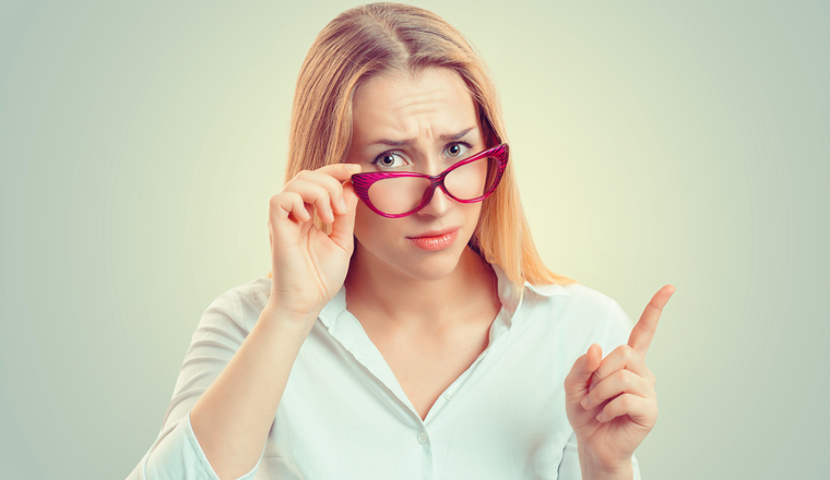 Attention, listen to me. Close up portrait of young woman wagging her finger isolated green wall background. Negative human emotions face expression, life perception, feelings, body language, attitude