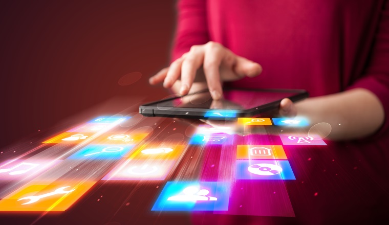 Hand holding tablet device with media application concept on background