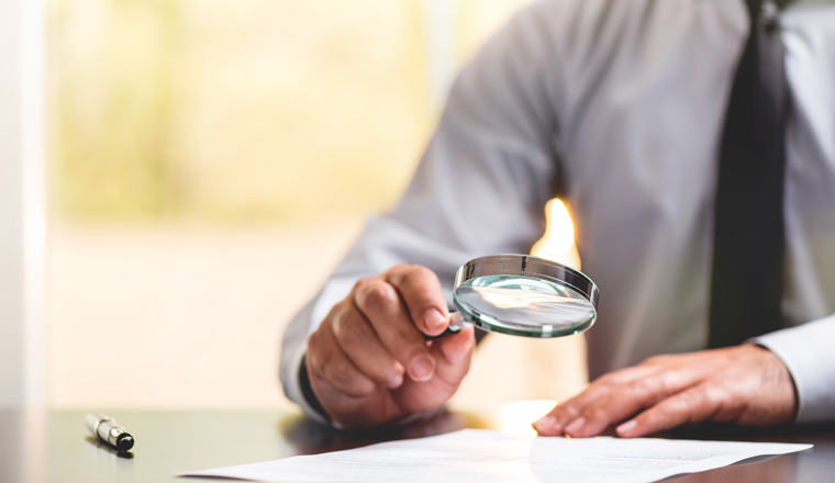 Businessman Reading Contract Details Before Signing