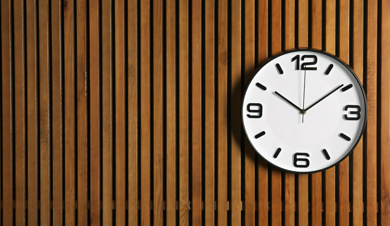 Stylish clock and space for text on wooden background. Time management