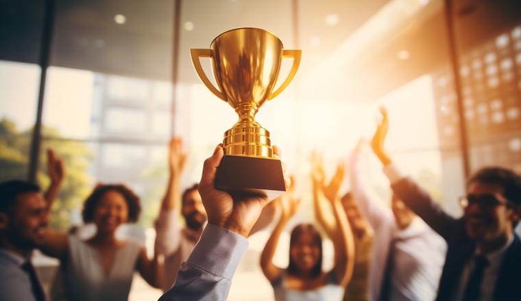 Happy worker team in office holding a golden trophy to celebrate succession of a big project with a sunset light effect background. Generative AI.