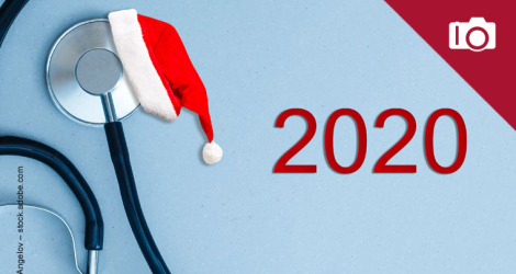 Medical stethoscope in a red Santa Claus hat, on a light blue background. Concept christmas and new year 2020. Creative medical winter background, postcard
